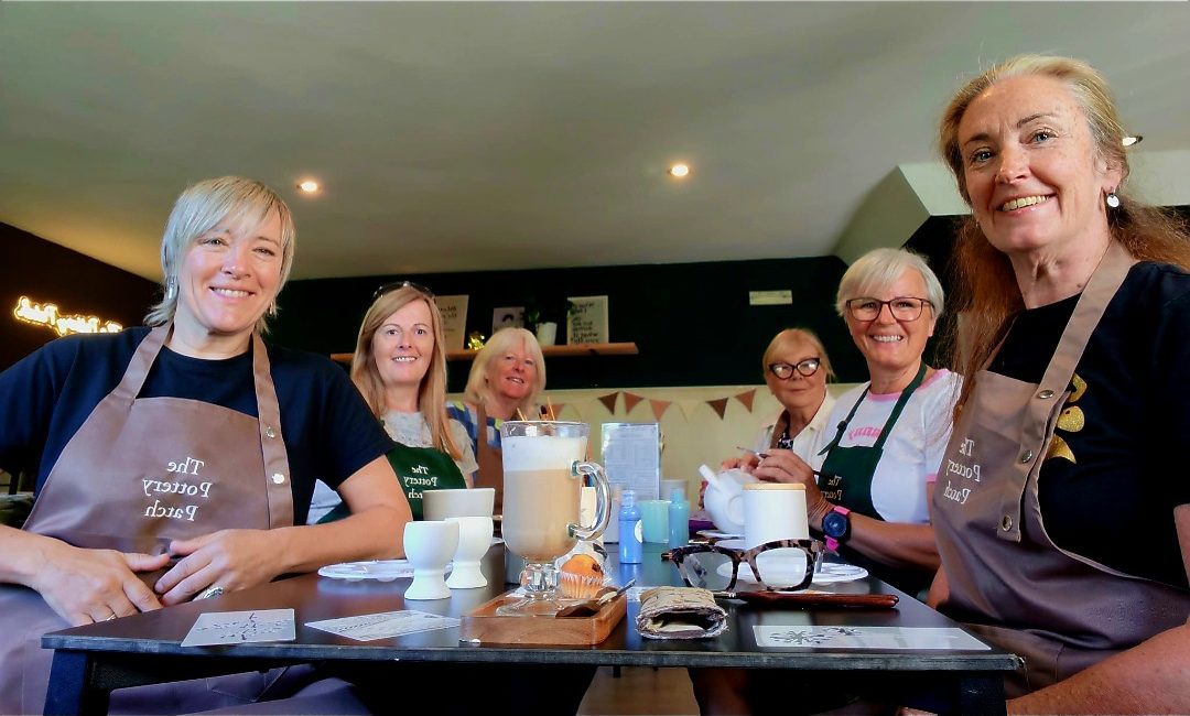 A group enjoying a pottery painting session together